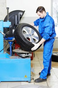 mechanic repairman installing automobile car wheel on tyre changers